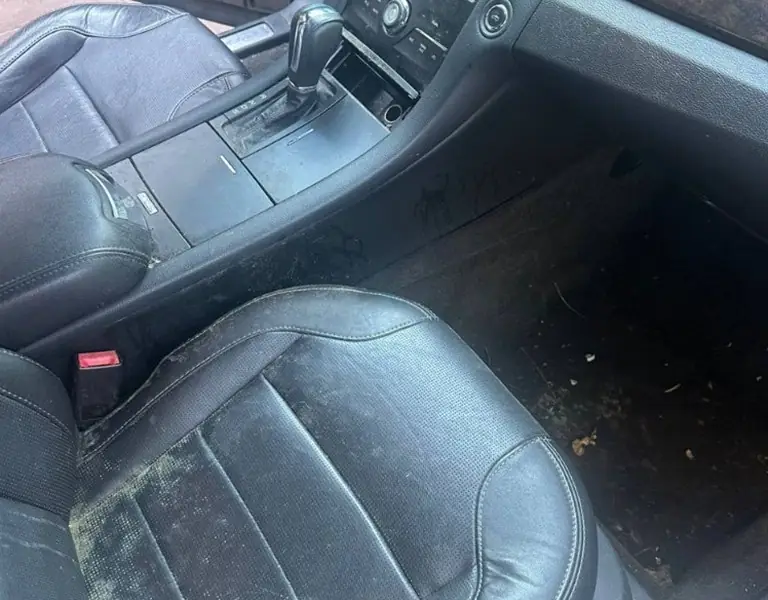 Dirty passenger seat and floor before detailing